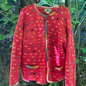 Colorful Wool sweater with wooden buttons fastened with leather.
